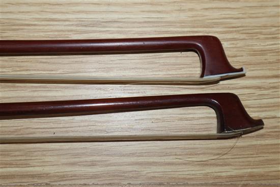 Two round stick violin bows with mother of pearl inlay, one with white metal mount